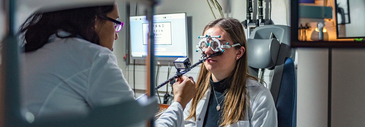 Student checking female students vision in Optometry lab