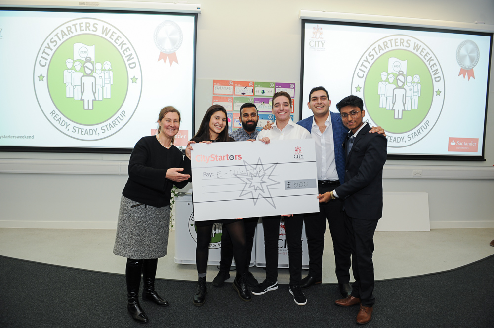 E-TukTuk team holding their CityStarters cheque presented by Dr Stefania Zerbinati