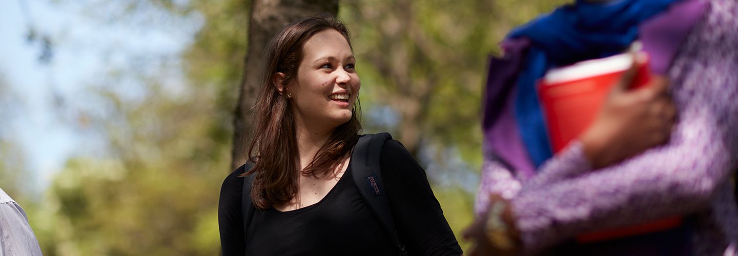 Female student smiling at another female student
