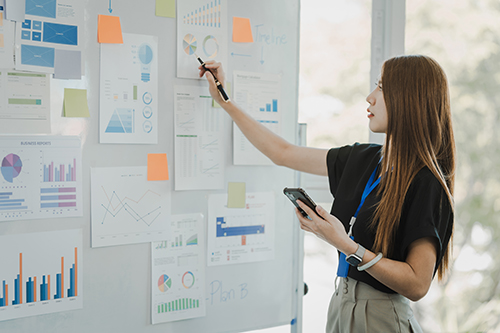 Female entrepreneur making plans on a wall