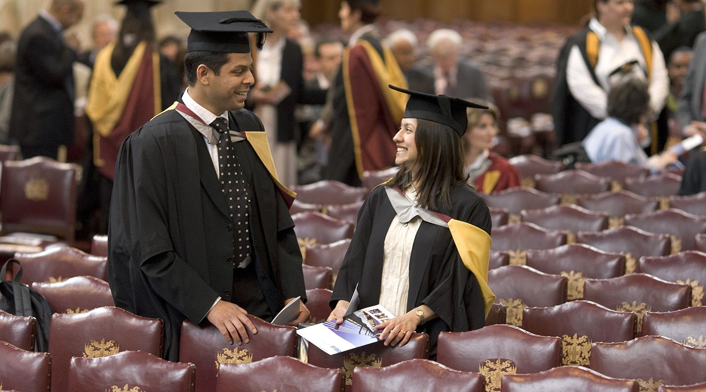New graduates pictured talking together at their ceremony