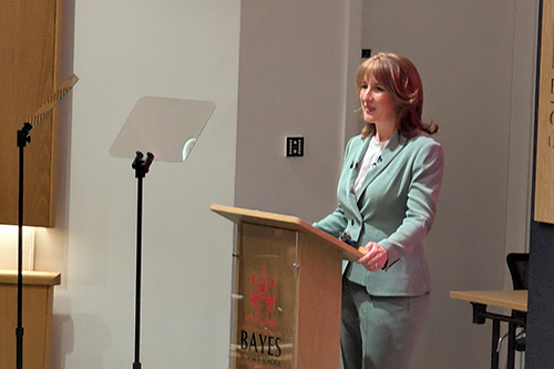 Woman stands at lectern