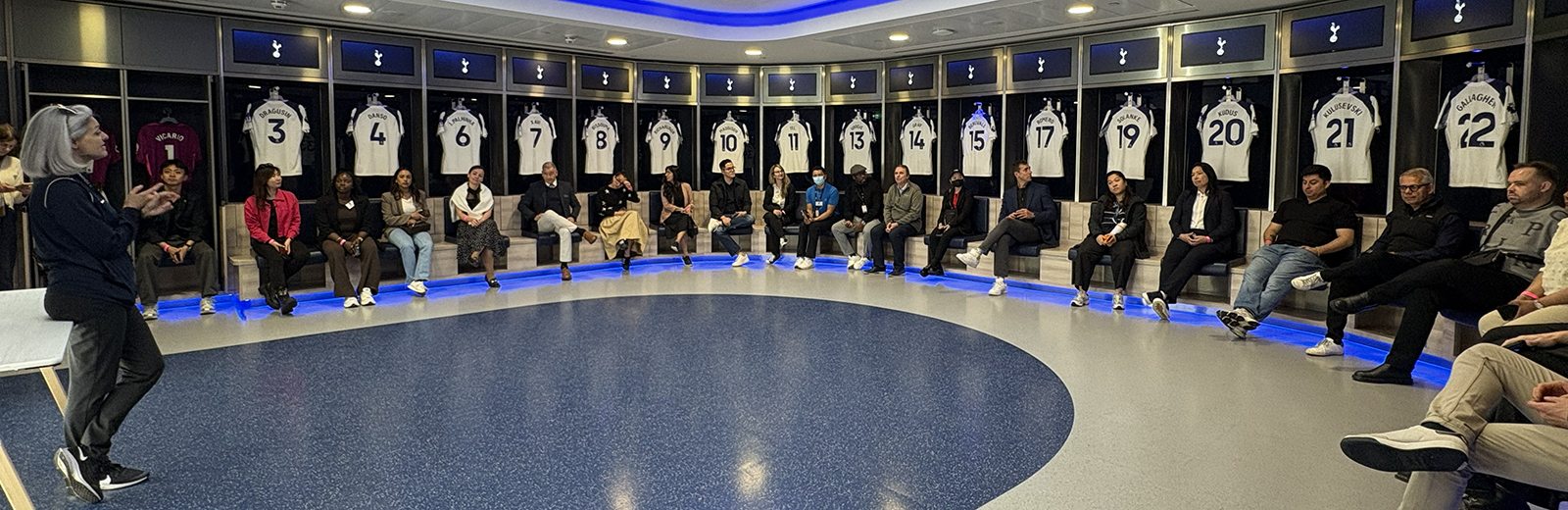 Students sitting in Tottenham Hotspur's dressing room
