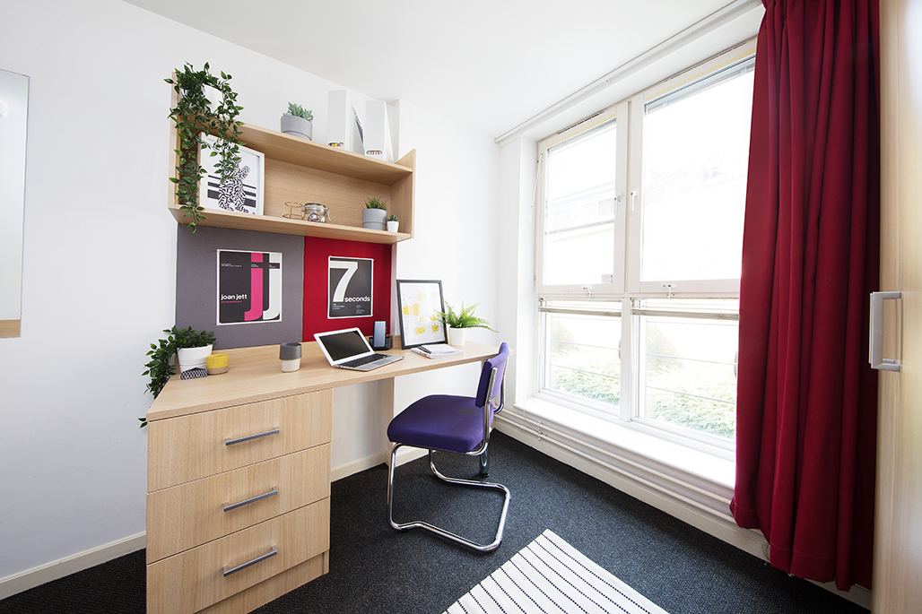 Romano court bedroom featuring desk area
