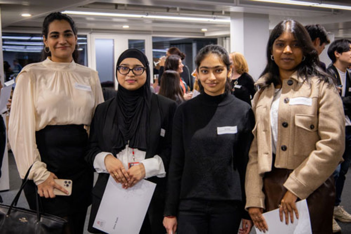 Four female Actuarial Science pose with their certificates 