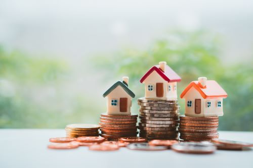 Houses sit atop a pile of money