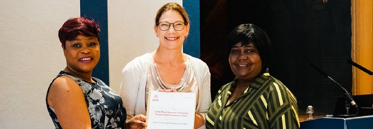 Judy Brook with two Lamb Ward awardee representatives