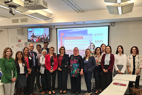 IWFSAS conference presenters lined up in front of a projector screen