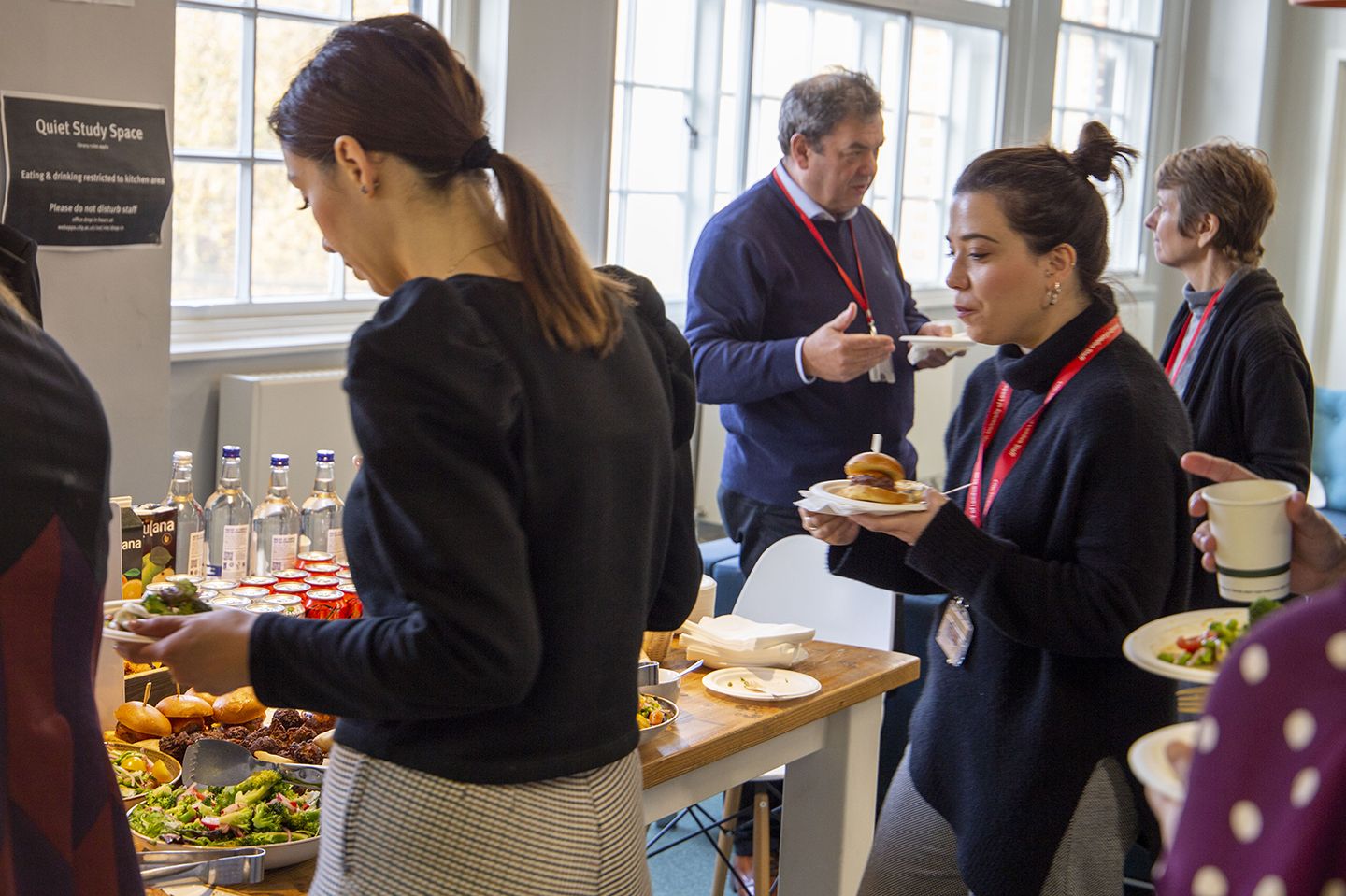 Scholars and academics networking over a buffet lunch