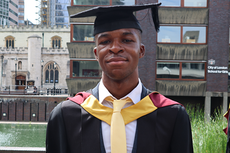 A head shot of a man wearing a cap and gown