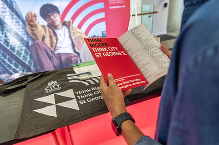 A City St George's prospective student browses the latest prospectus