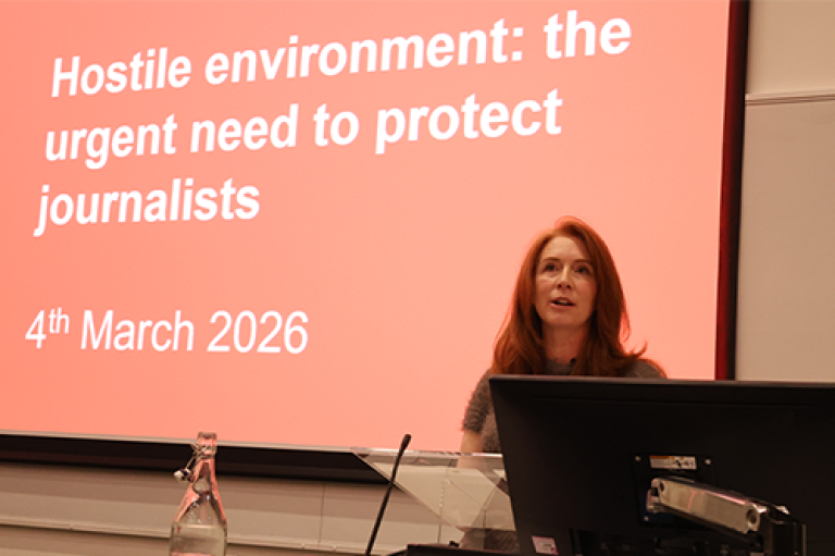 A woman speaks at a lecture 