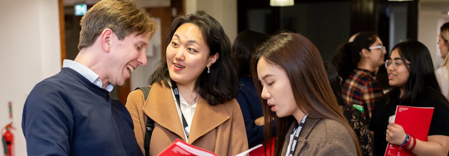 Students talking at a university networking event.