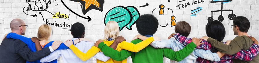 Diverse group of people looking at a wall covered with ideas.