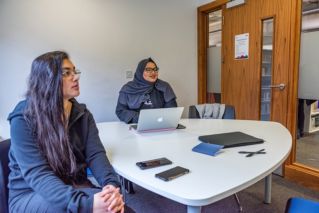 Two students using private library working space