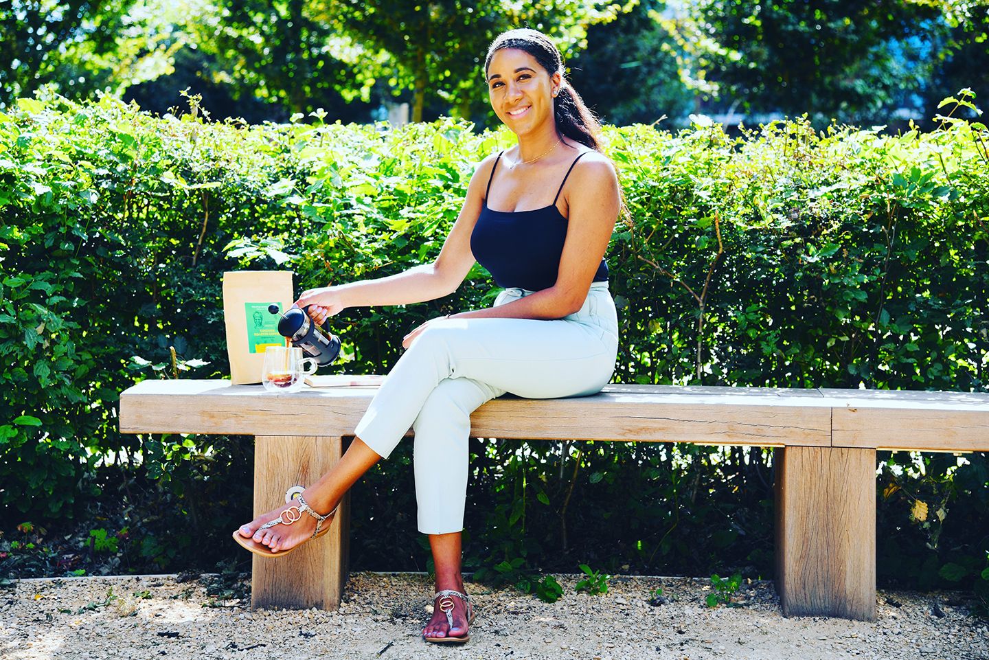Lauren Le Franc smiling with the little coffee company packaging beside her