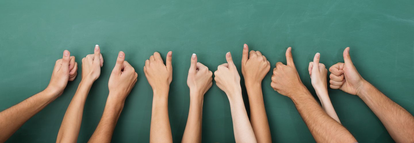 A variety of people's hands doing a thumbs up gesture