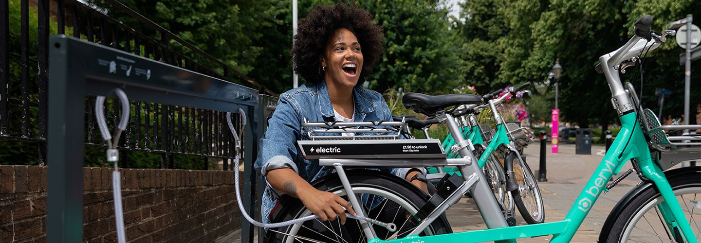 Woman happy unlocking beryl's electric bike-share