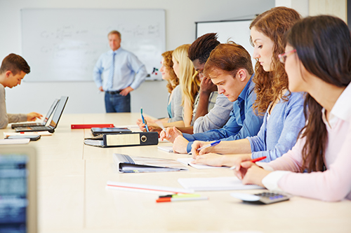 A group of apprentices write down instructions