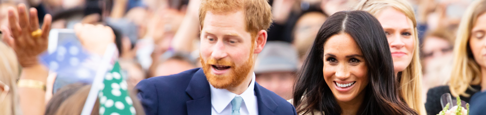 Harry and Meghan amidst an audience