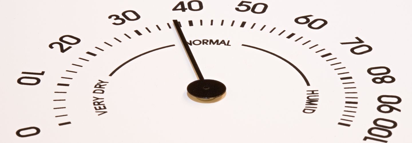 Dial-type humidity sensor reading with the dial arm pointing to a 