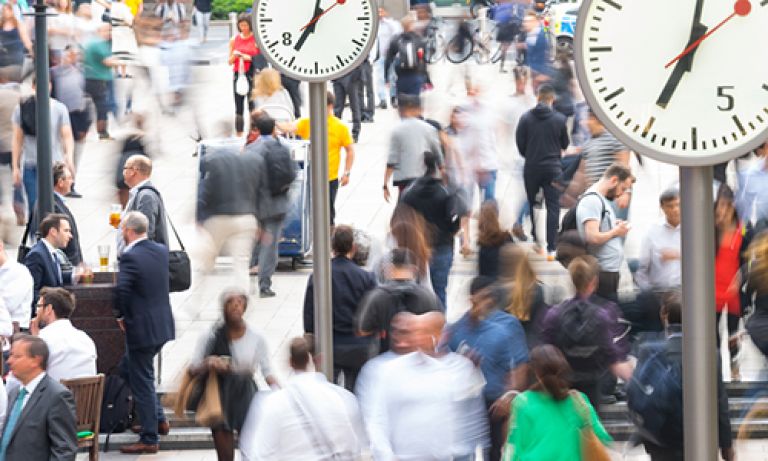 People walking through a busy London street.