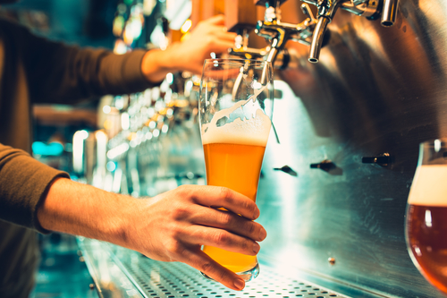 Bartender pours a pint