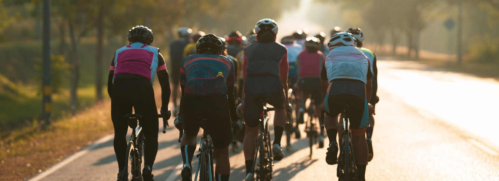 Cyclists training ride towards the sunset