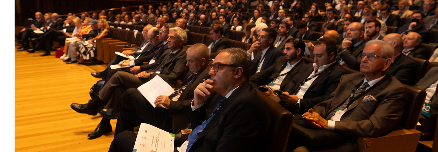 An audience listen to a speaker we can't see
