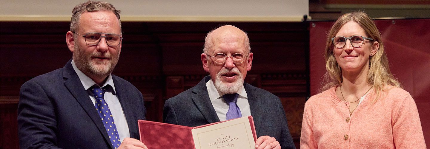 Left: Prof Rory Fitzgerald stands next to a man holding an award in an open book, and stand next to another woman on the right. 