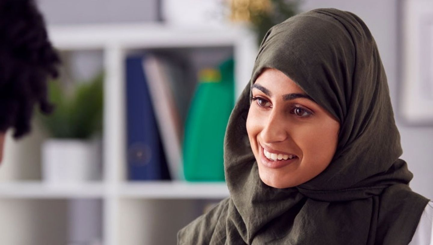 Female Doctor Or Consultant Wearing Headscarf Having Meeting With Female Patient To Discuss Scans