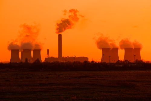 Energy inftastructure set against a bright orange sunset