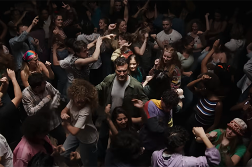 Man dancing in the middle of a crowded nightclub