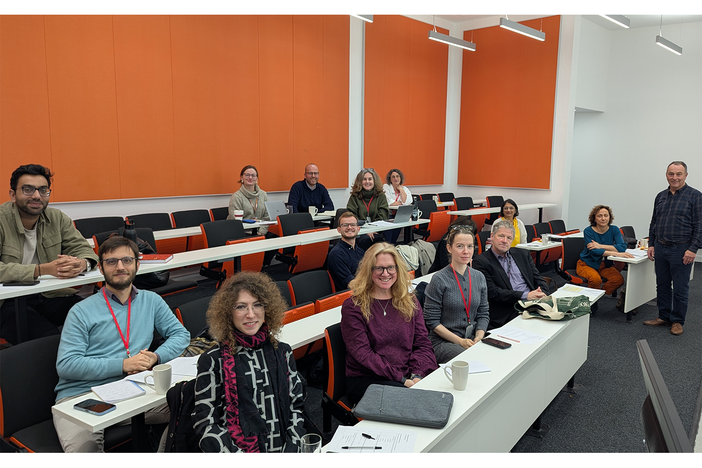 Group photo of speaker and audience in a lecture theatre.