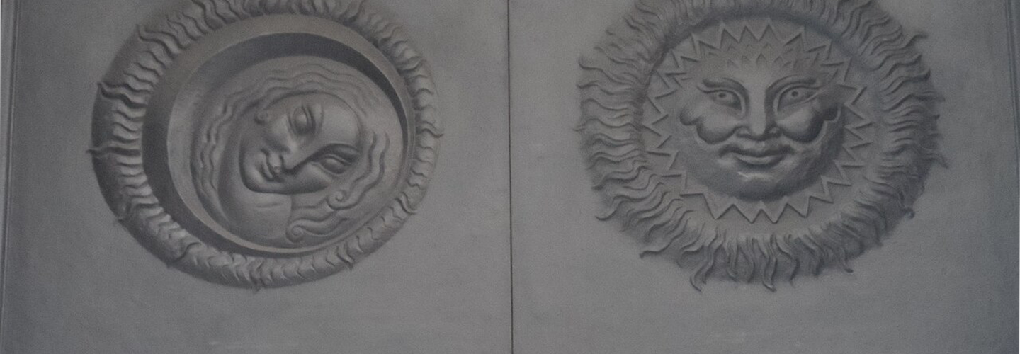 Images of the sun and the moon sculptured into a large door
