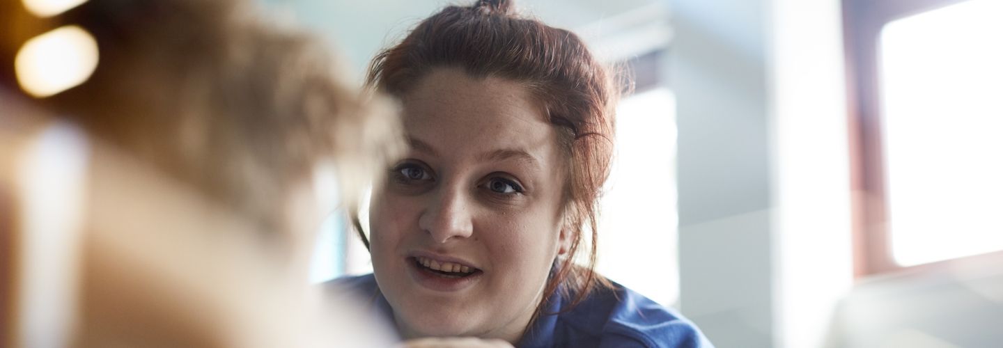 Female student midwife talking to a patient