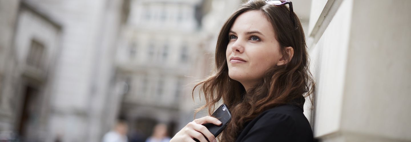 Female student holding a mobile phone