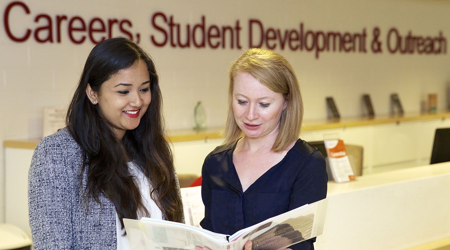 Female student gets career advice from an adviser at City
