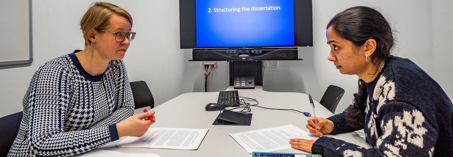A tutor having an English one to one tutorial with an MA student