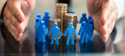 A group of toy figures surround a pile money