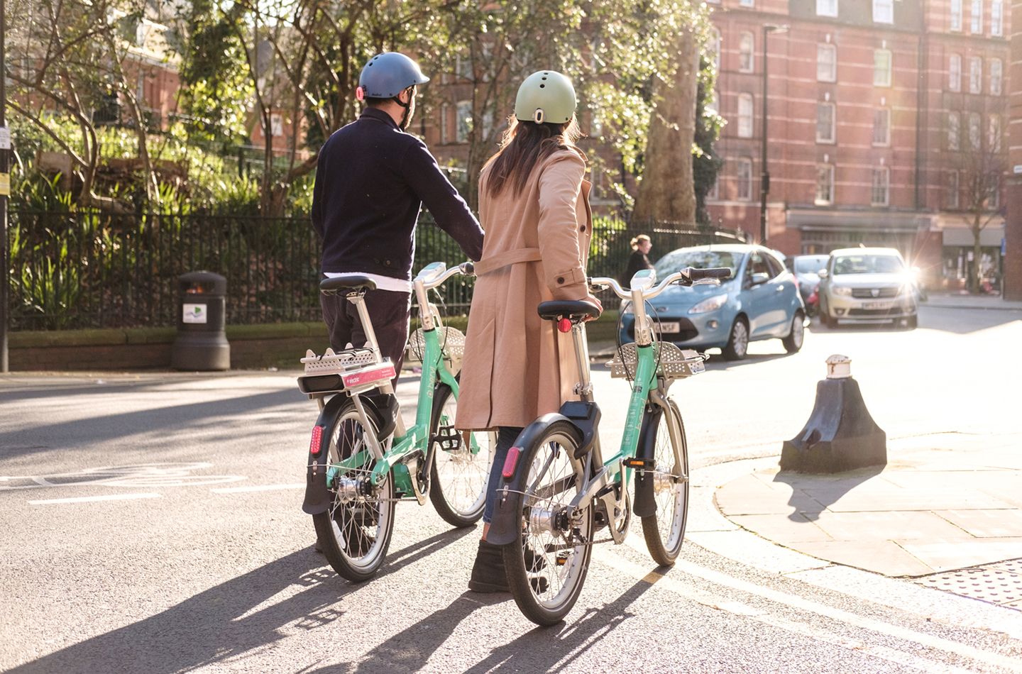 Two people walking with beryl bikes