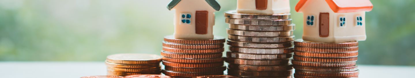 A house sits atopm a pile of money