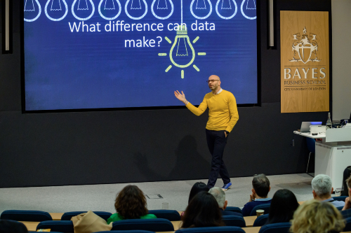 Dimi walking around the stage during his presentation