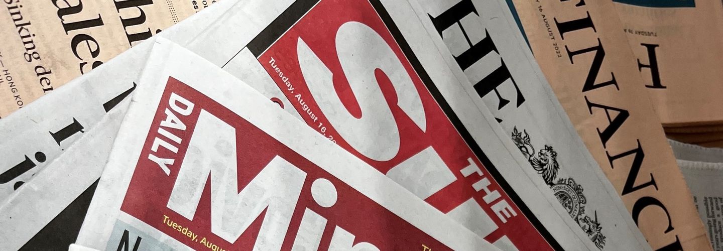 Image of newspapers spread, with parts of their names visible: The Mirror, The Sun, The Financial Times