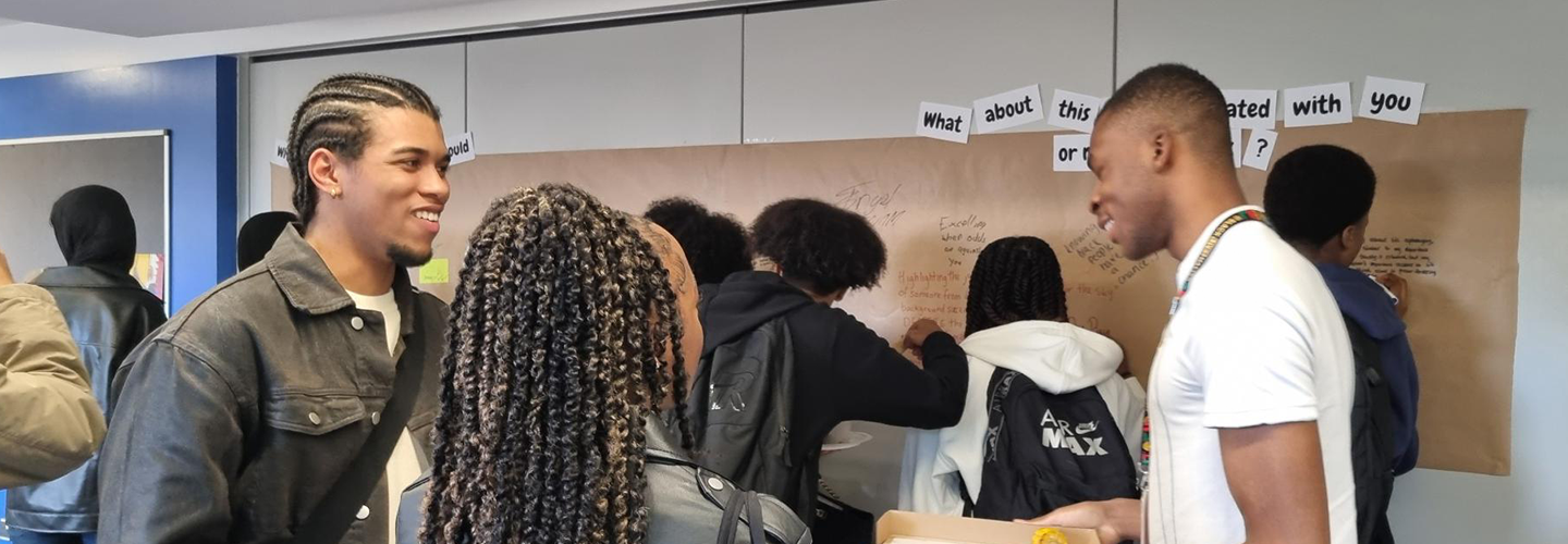 Three students speak together at an event