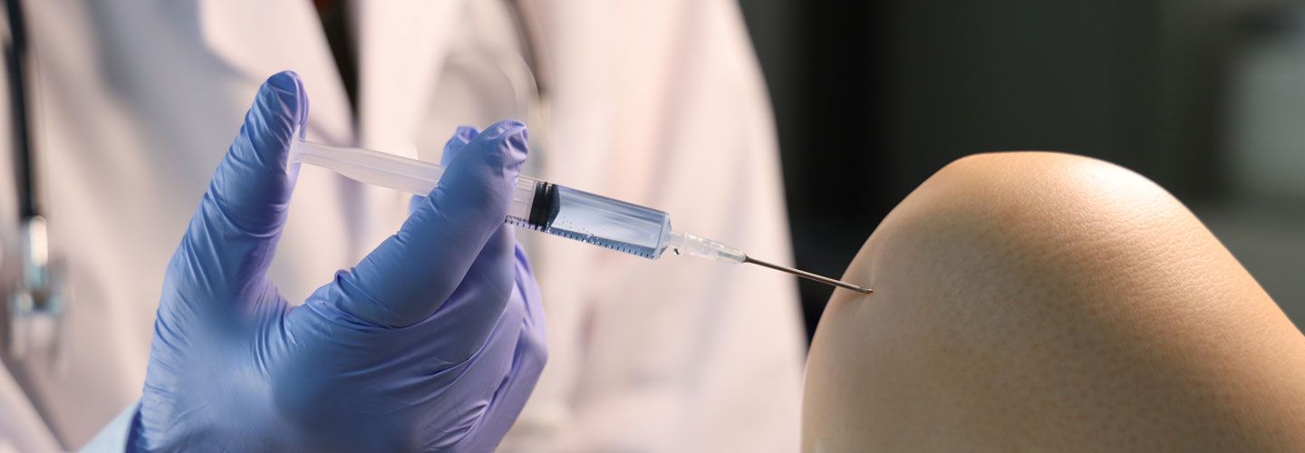 Image of a young woman receiving injection of botox to forehead 