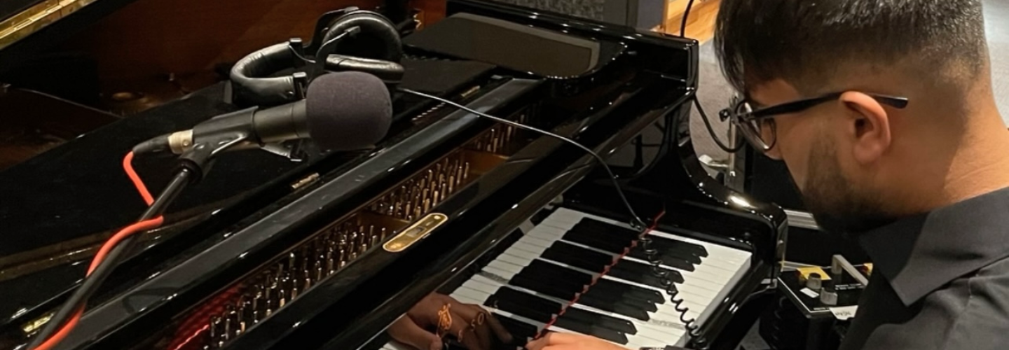 Rohit Sands is seen playing the piano in a studio