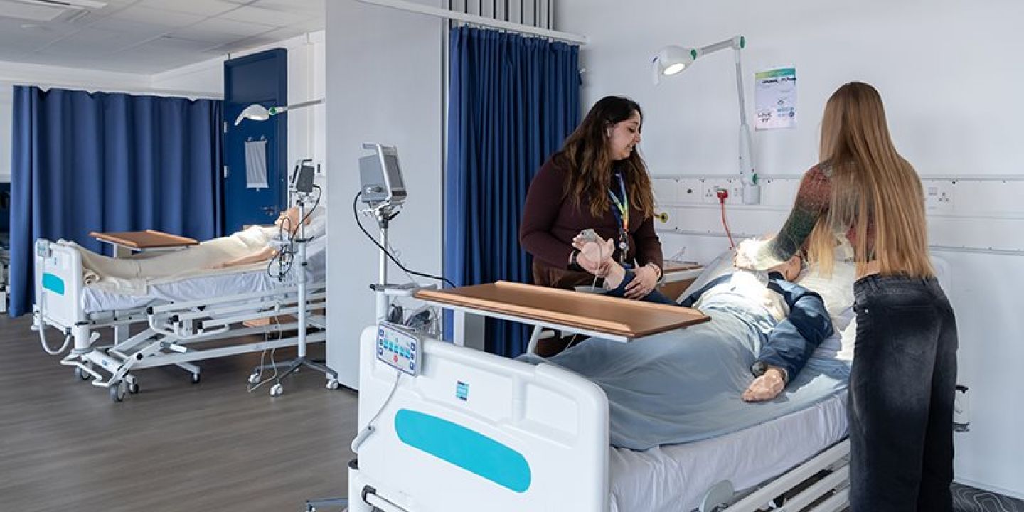 Students tending to mannequin in simulation physiotherapy teaching laboratory