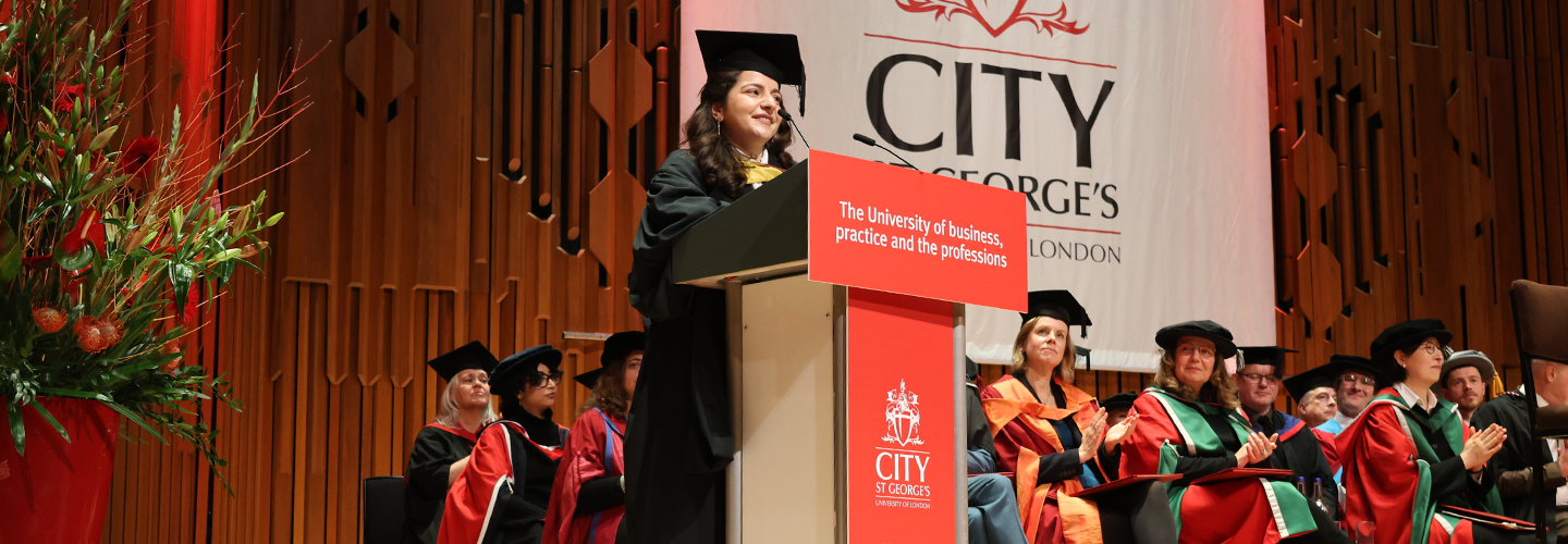 Laura gives a speech on stage