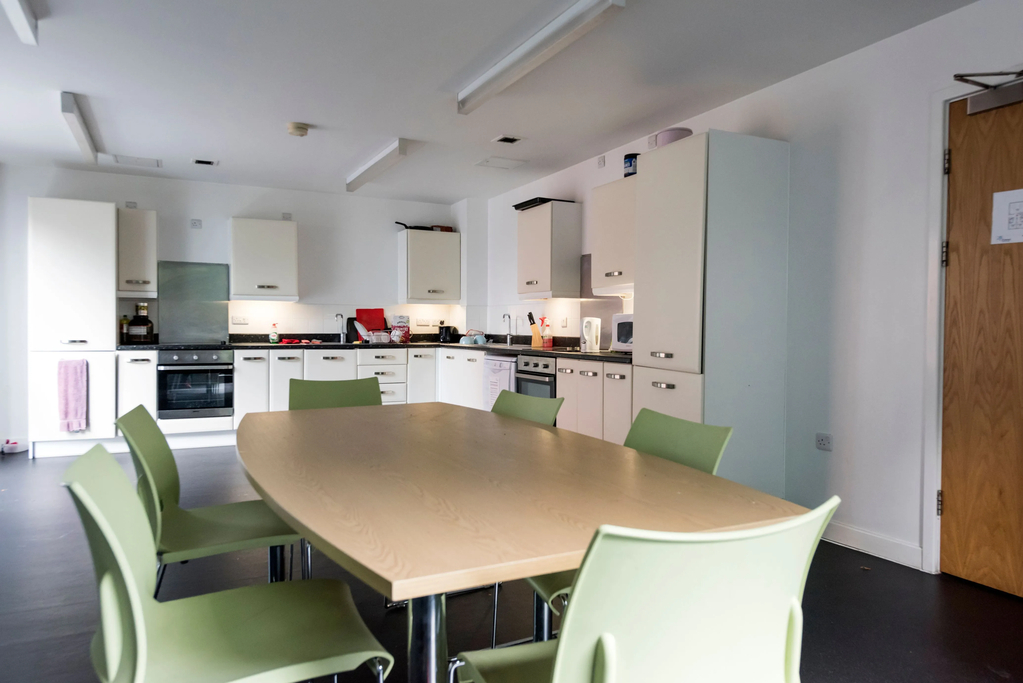 Communical Halls kitchen with dining table and chairs